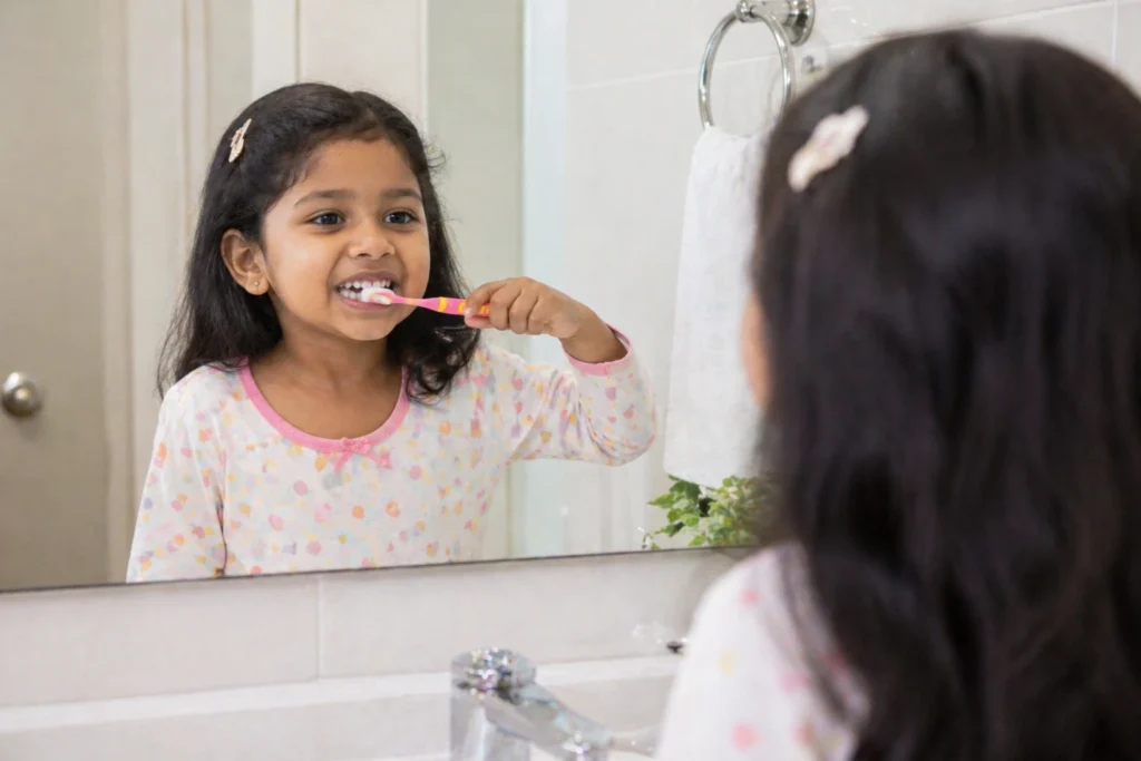 Child brushing teeth with guidance from Dr. Swapnil Rachha at Soulful Dental Care Pune