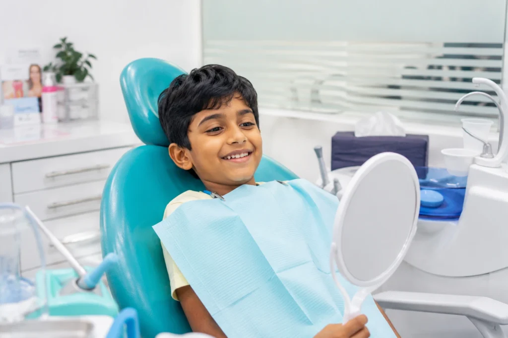 Pediatric dentist gently treating a child's tooth using minimally invasive caries technique